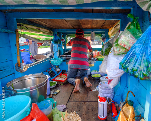 A man works serving pho for breakfast in the Cai Rang floating market in Can Tho, Mekong Delta, Vietnam