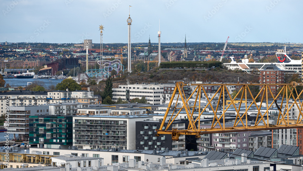 Stockholm,  Sweden - 2020.10.18: Building crane focused with the Stockholm skyline in the background. Scandinavian architecture and real estate development concept.