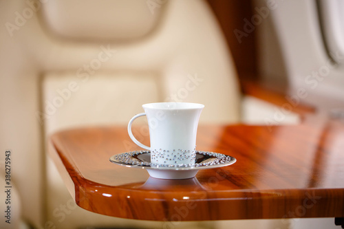 Cup of hot tea served in business class