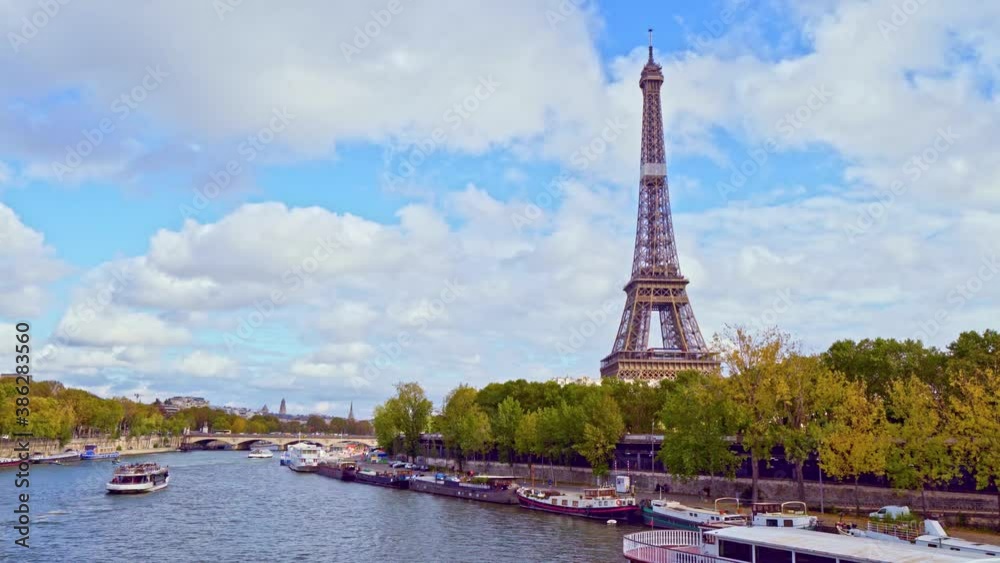 4K vedio of amazing view of the Eiffel tower from Bir-Hakeim bridge, over the river Seine , Paris, France. Paddle steamer and glass boats on river at a cloudy but sunny autumn day. 4K vedio of amazing view of the Eiffel tower from Bir-Hakeim bridge, over the river Seine , Paris, France. Paddle steamer and glass boats on river at a cloudy but sunny autumn day.