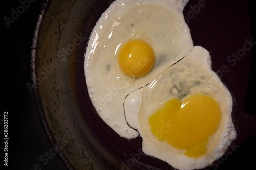 A fried egg in a frying pan on a white background