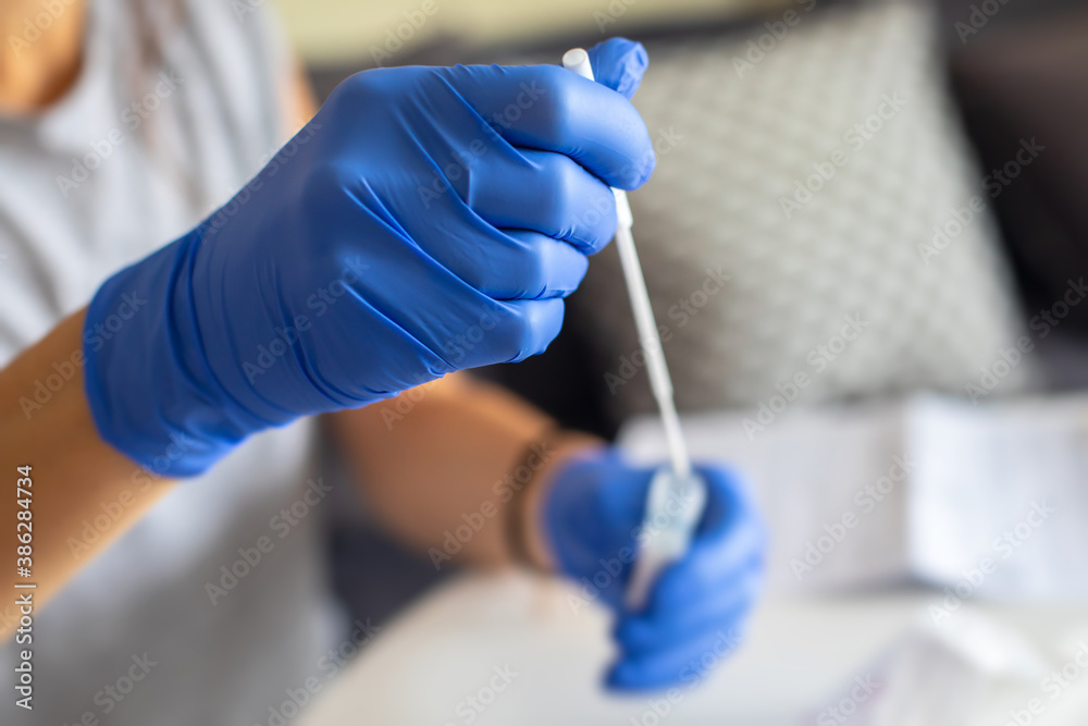 Process of coronavirus testing examination at home, COVID-19 swab collection kit, test tube for taking OP NP patient specimen sample, testing carried out, patient receiving a corona test Process of coronavirus testing examination at home, COVID-19 swab collection kit, test tube for taking OP NP patient specimen sample, testing carried out, patient receiving a corona test