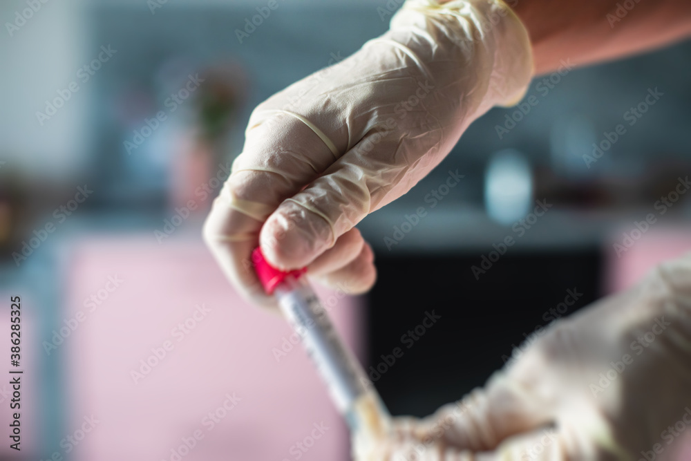 Process of coronavirus testing examination at home, COVID-19 swab collection kit, test tube for taking OP NP patient specimen sample, testing carried out, patient receiving a corona test