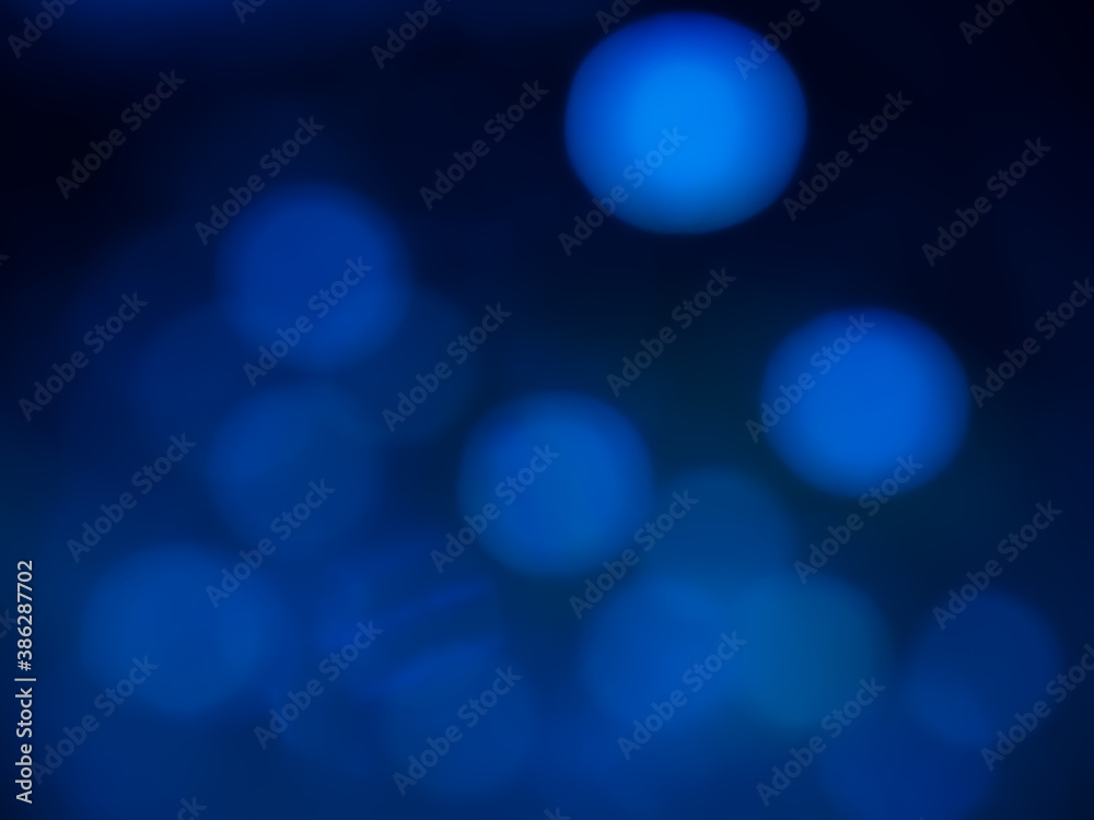 Blurred blue circles bokeh style on dark blue background