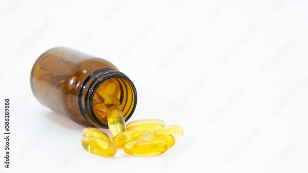 Omega 3 capsule pouring from bottle on white background. Health care concept Omega 3 capsule pouring from bottle on white background. Health care concept