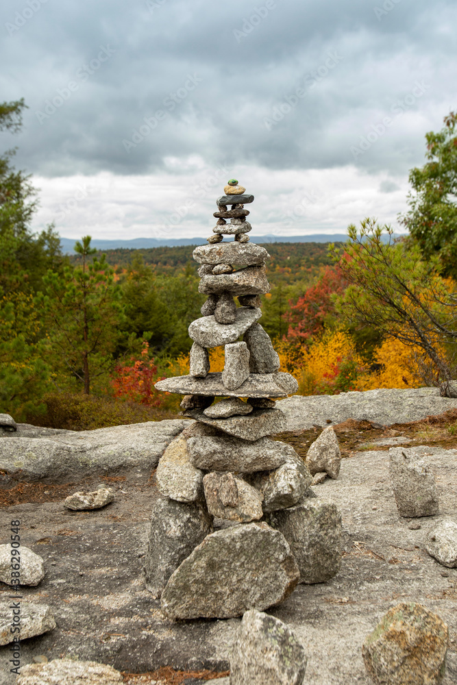 Cairn topped with a painted rock turtle guides hikers among the fall foliage of Pisgah State Park