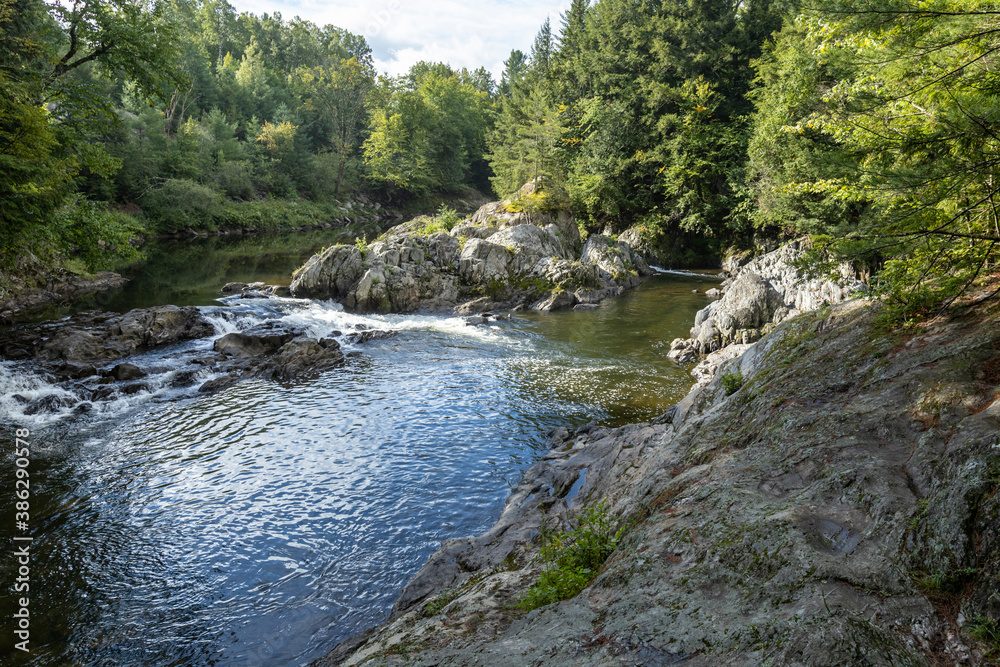 Fototapeta premium The Missisquoi River gathers in a natural pool above Big Falls