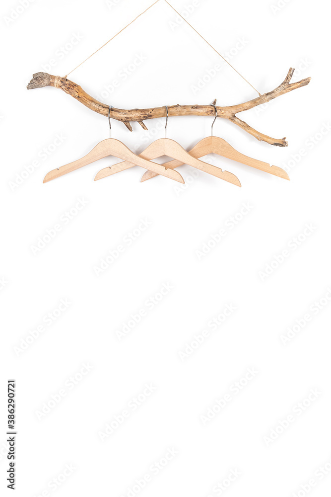 Three hangers on a thick wooden stick, great design for any purposes. Concept Eco-Friendly Homes or Season sale. Front view Three hangers on a thick wooden stick, great design for any purposes. Concept Eco-Friendly Homes or Season sale. Front view