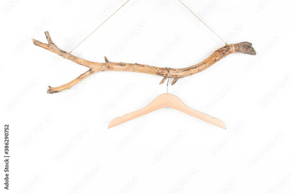 Obraz premium One hanger on a thick wooden stick, great design for any purposes. Concept Eco-Friendly Homes or Season sale. Front view