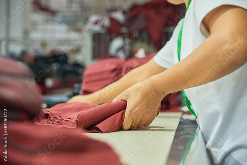 Employee's hands working in clothing factory