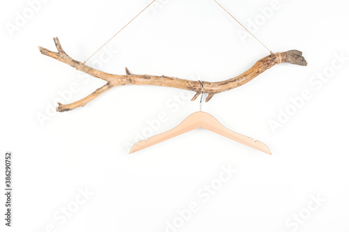 One hanger on a thick wooden stick, great design for any purposes. Concept Eco-Friendly Homes or Season sale. Front view