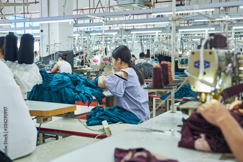 Employee's working with their sewing machines in clothing factory
