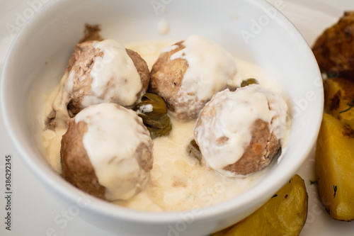 View of Koenigsberger klops, a specialty traditional german style cooked meat balls in Kaliningrad, Kaliningrad Oblast, Russia, served with mashed potatoes in a white sauce with capers