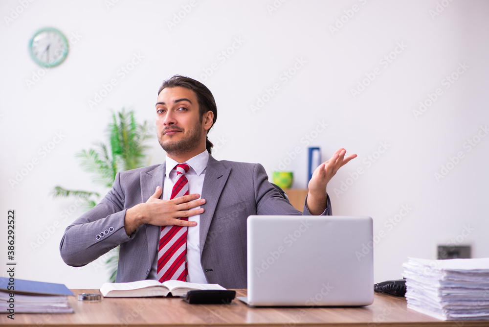 Young male employee working in the office Young male employee working in the office