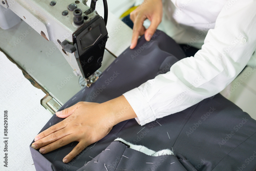 fabric is sewn using a sewing machine by a tailor in the garment convection production room