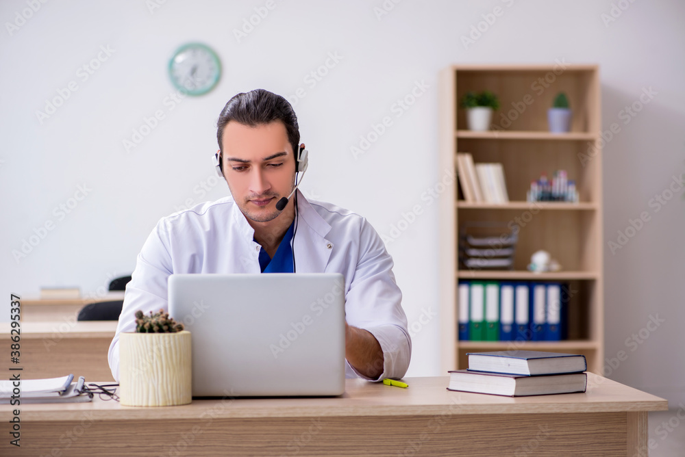 Young male doctor in telemedicine concept Young male doctor in telemedicine concept