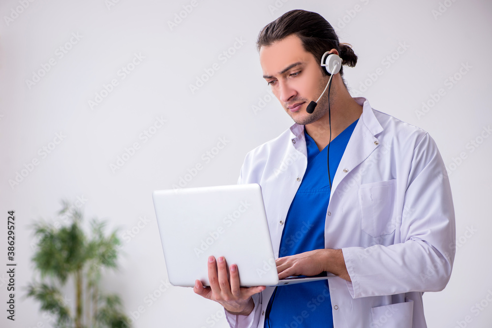 Young male doctor in telemedicine concept Young male doctor in telemedicine concept