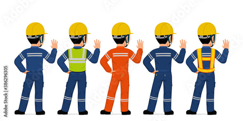 Isolated industrial worker is raising his right hand