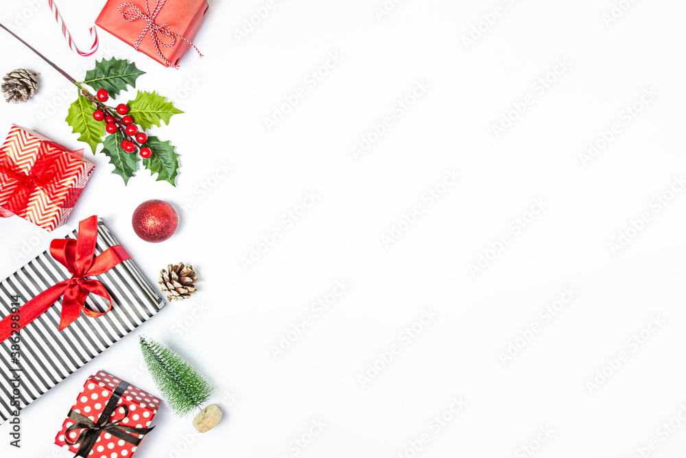 Gift boxes wrapped in striped and dotted black and white and red paper over white background. Christmas presents and ornament preparation. Copy space.