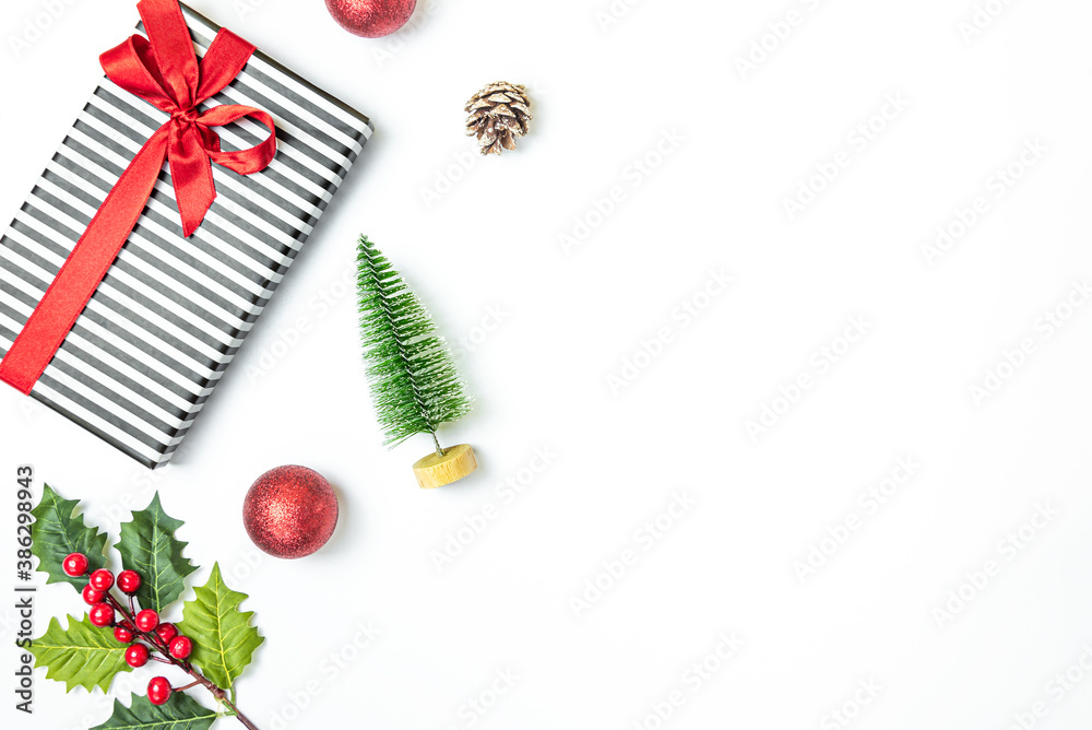 Gift box wrapped in striped black and white over white background. Christmas presents and ornament preparation. Copy space.