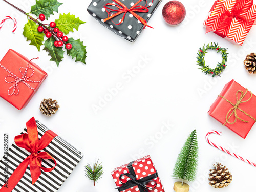 Obraz na płótnie Gift boxes wrapped in striped and dotted black and white and red paper over white background. Christmas presents and ornament preparation. Copy space. w salonie