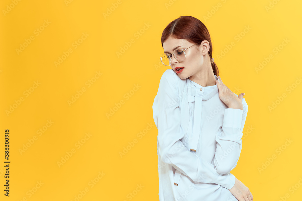 woman in white shirt wearing glasses red lips elegant style yellow isolated background