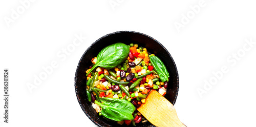 Vegetable mix in authentic pan on white background. Budget-friendly menu or World Vegan Day. Close-up