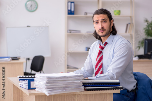 Young male employee unhappy with excessive work