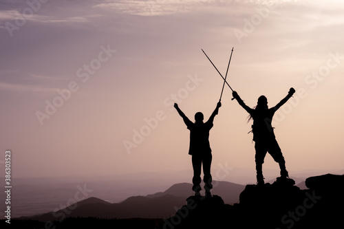 Success, achievement and accomplishment concept with hiking people cheering and celebrating of joy with arms raised outstretched up on trekking hike outside. Hikers having fun at sunrise © emerald_media