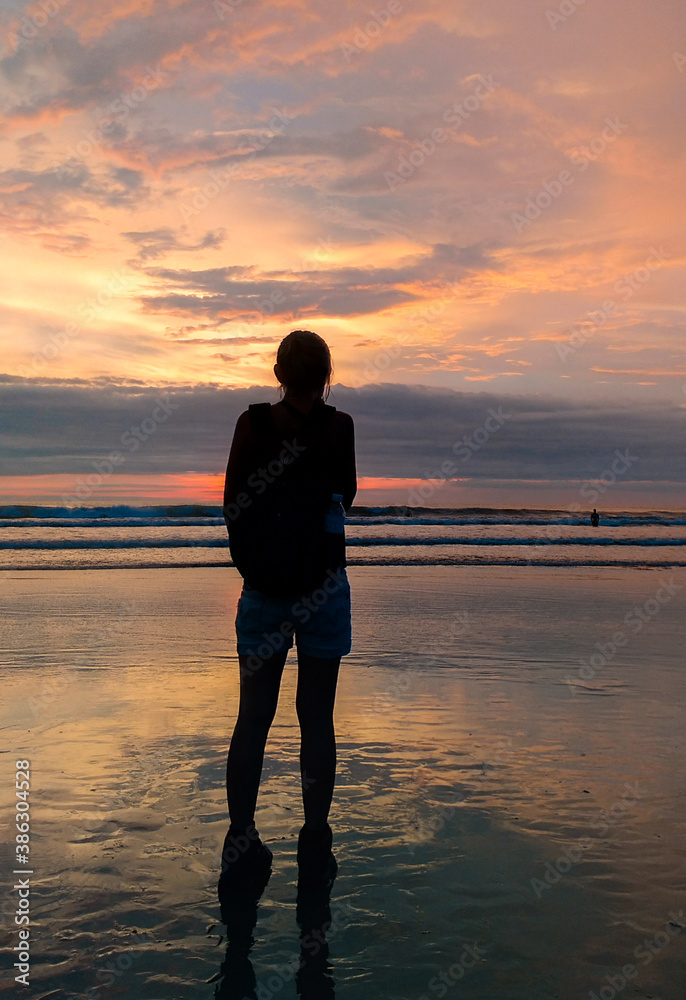 A woman enjoy the beauty of Petitenget Beach Bali Indonesia A woman enjoy the beauty of Petitenget Beach Bali Indonesia