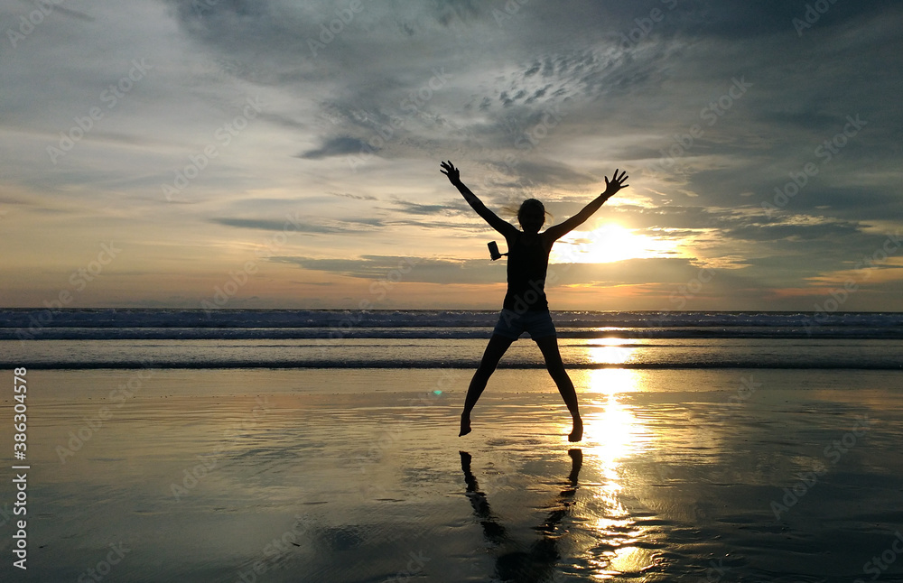 A woman enjoy the beauty of Petitenget Beach Bali Indonesia