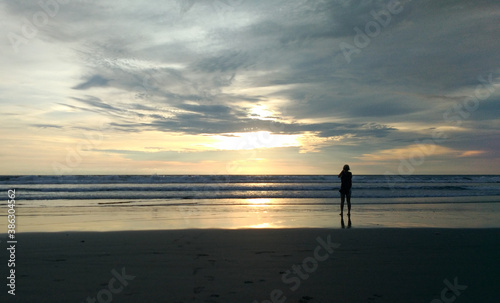 A woman enjoy the beauty of Petitenget Beach Bali Indonesia © Handoko