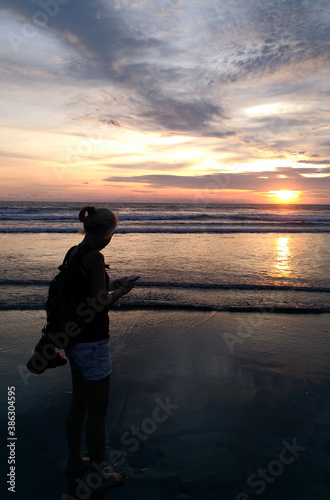 A woman enjoy the beauty of Petitenget Beach Bali Indonesia