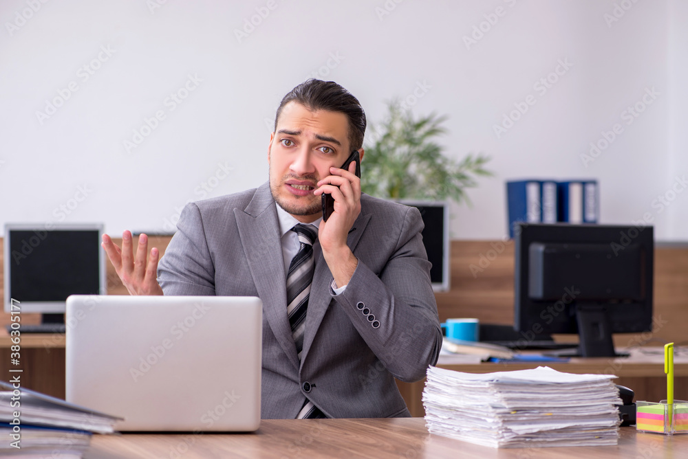 Young male employee working in the office Young male employee working in the office