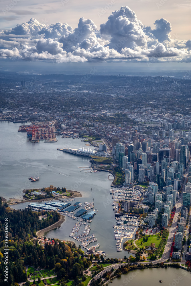 Downtown Vancouver, British Columbia, Canada. Aerial View of the Modern Urban City, Stanley Park, Harbour and Port. Viewed from Airplane Above during a sunny morning.