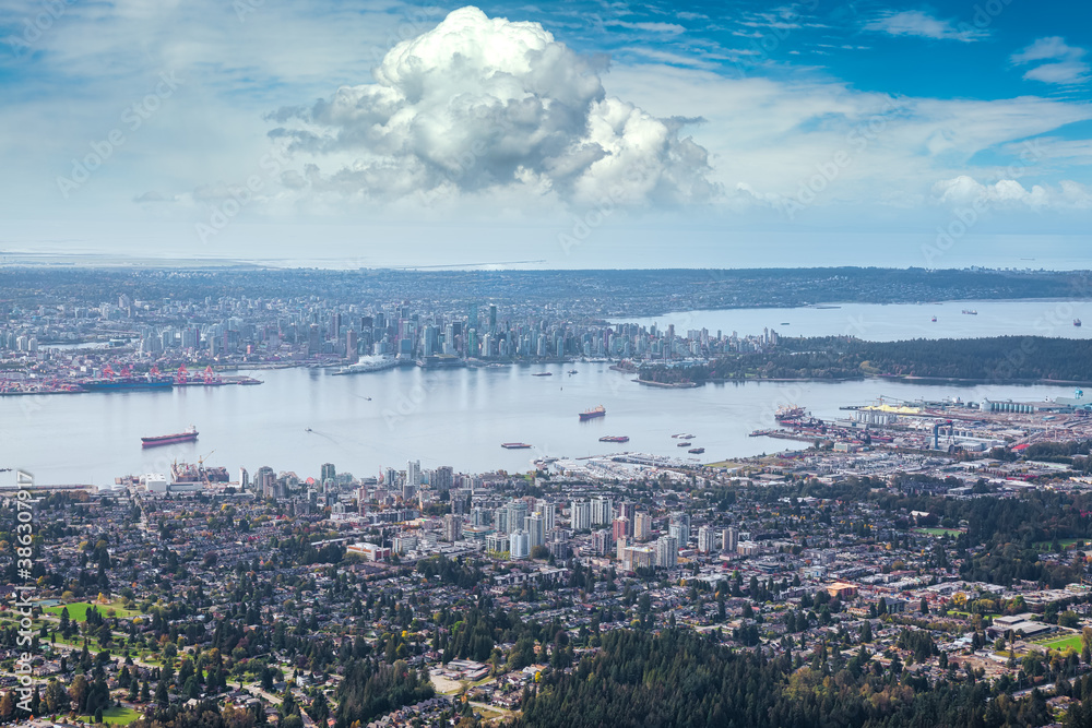 Obraz premium Aerial view of North Vancouver with Downtown City in the Background. Taken during sunny morning in British Columbia, Canada.