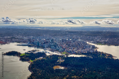 Downtown Vancouver, British Columbia, Canada. Aerial View of the Modern Urban City, Stanley Park, Harbour and Port. Viewed from Airplane Above during a sunny morning. Artistic Render