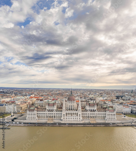 Aerial drone shot of Hungarian Parliament with overcast clouds in Budapest Winter morning © Davidzfr