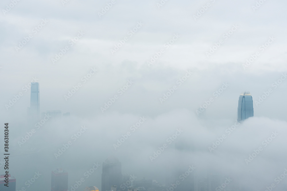 Skyline of Victoria harbor of Hong Kong city in fog