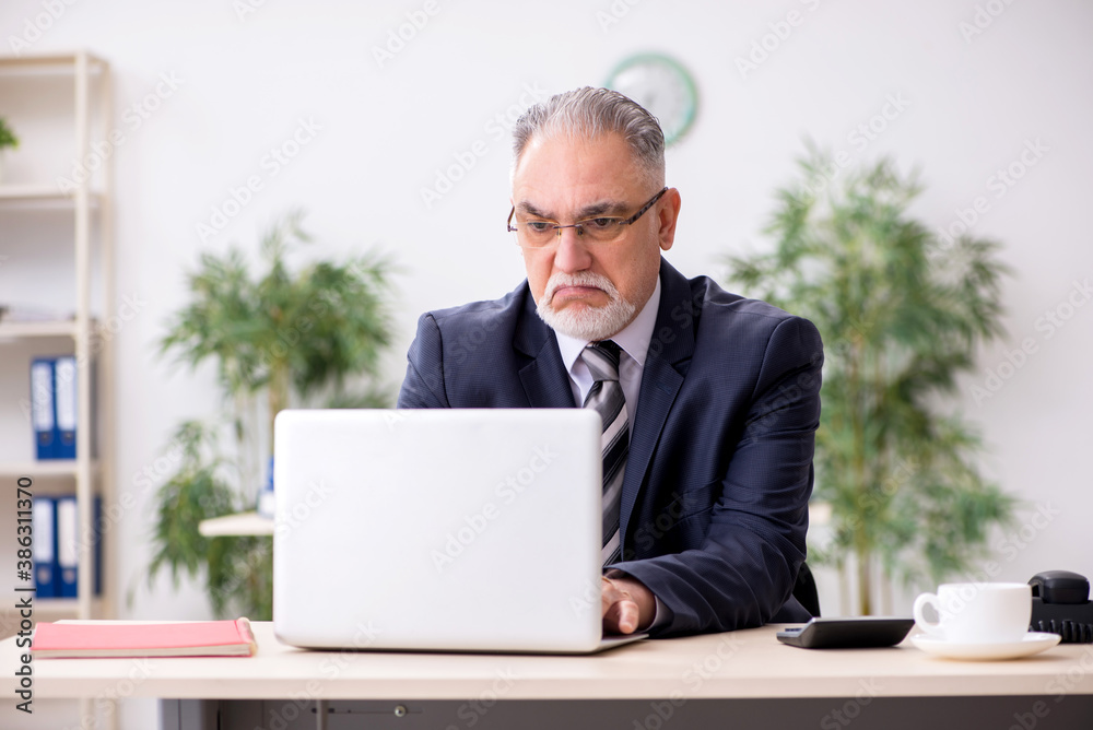 Old male boss employee working during pandemic Old male boss employee working during pandemic
