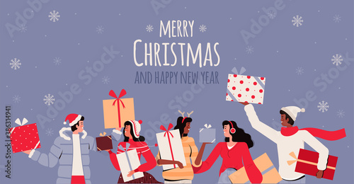 Joyful people in winter clothes hold and give gifts. Men and women are having fun at the celebration. Christmas presents