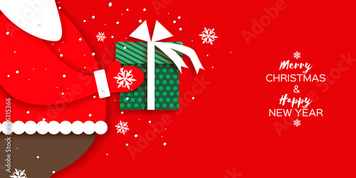 Merry Christmas Greetings Card with Santa Claus hands holding green giftbox with white bow. Happy New Year in papercraft style. Red background. Winter holidays.