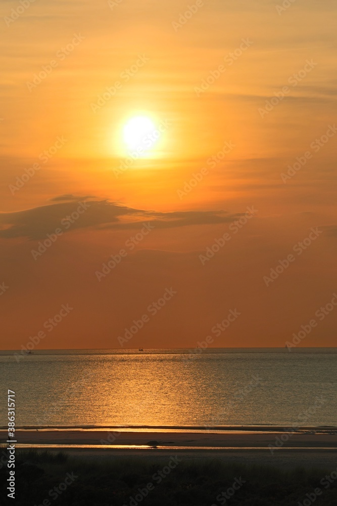 sunset on the beach of an island