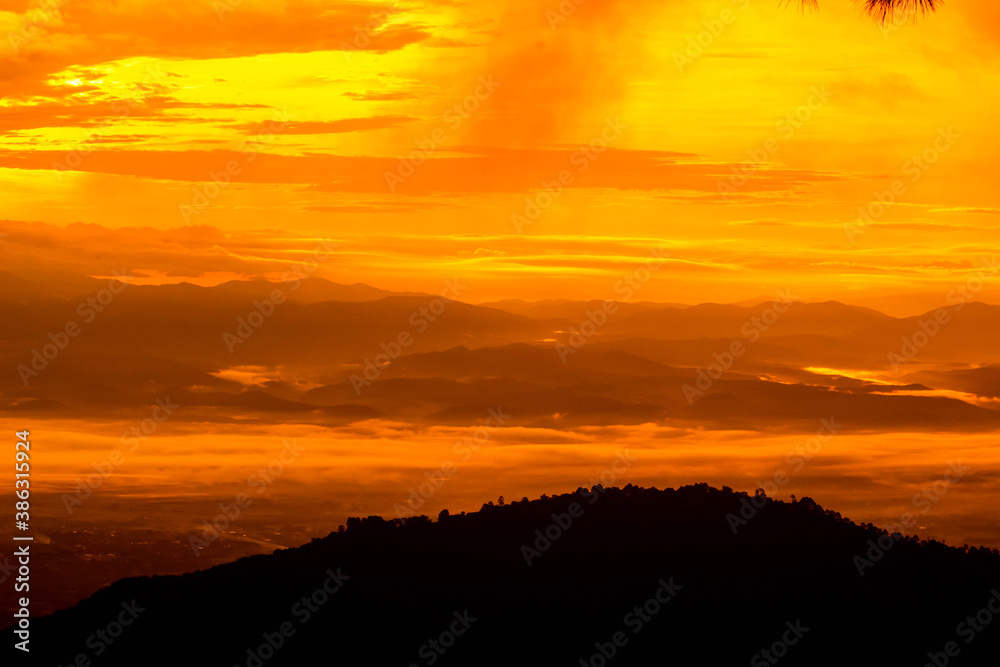 Beautiful landscape at sunset sky with clouds on peak of mountains.