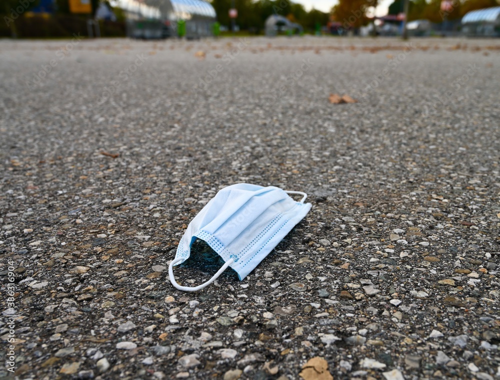 Discarded or lost face mask on the pavement. Discarded or lost face mask on the pavement.