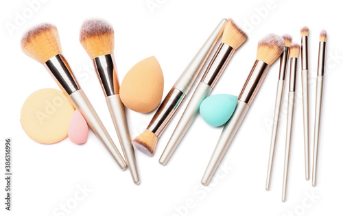 Set of makeup brushes with sponges on white background