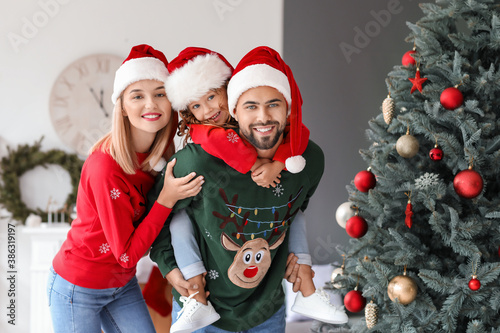 Young family at home on Christmas eve