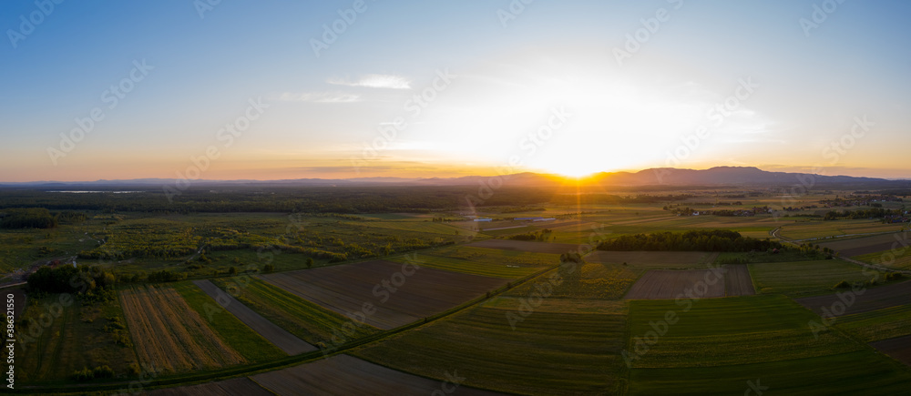 Fototapeta premium Aerial view of sunset above plantations at the countryside, Croatia.