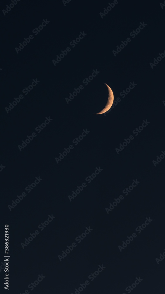Image of the crescent moon taken during the last minutes of blue hour time Image of the crescent moon taken during the last minutes of blue hour time