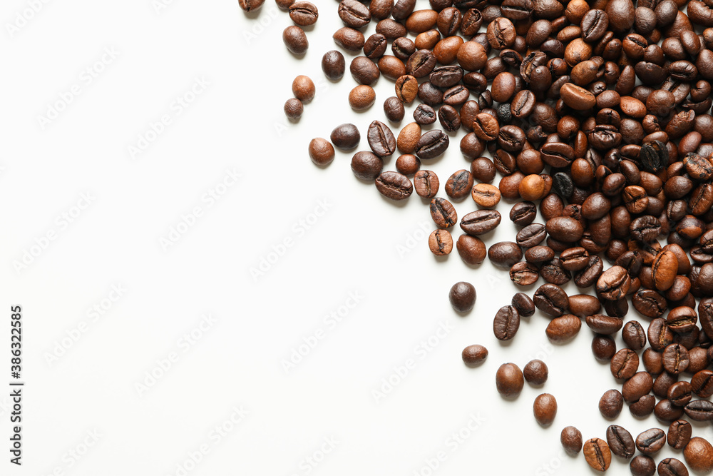 Roasted coffee beans on white background, space for text Roasted coffee beans on white background, space for text
